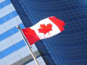 canadian flag in front of building